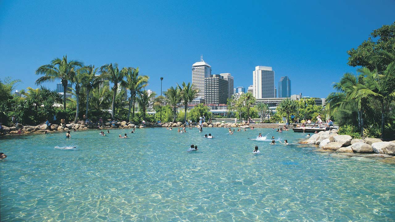 Brisbane's Southbank community pool with people swimming and enjoying the sunny, blue skies