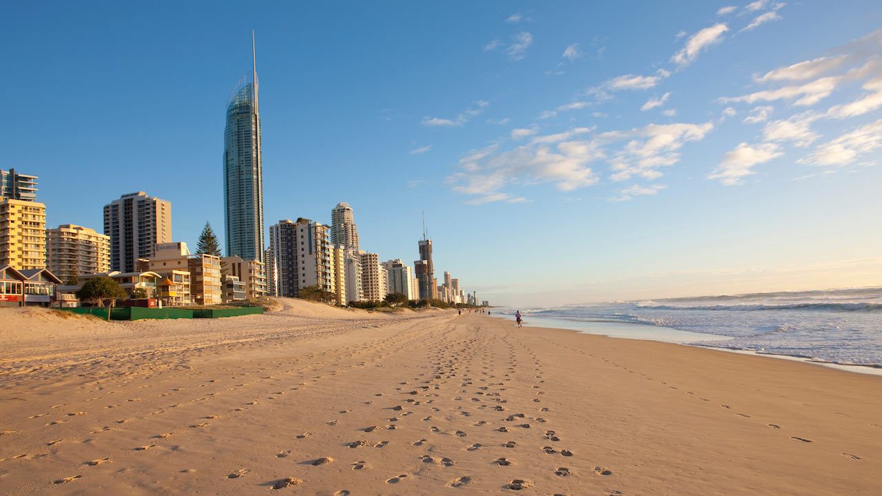 Footprints in the sand on Surfer's Paradise Beach sandwiched between the city line and the ocean