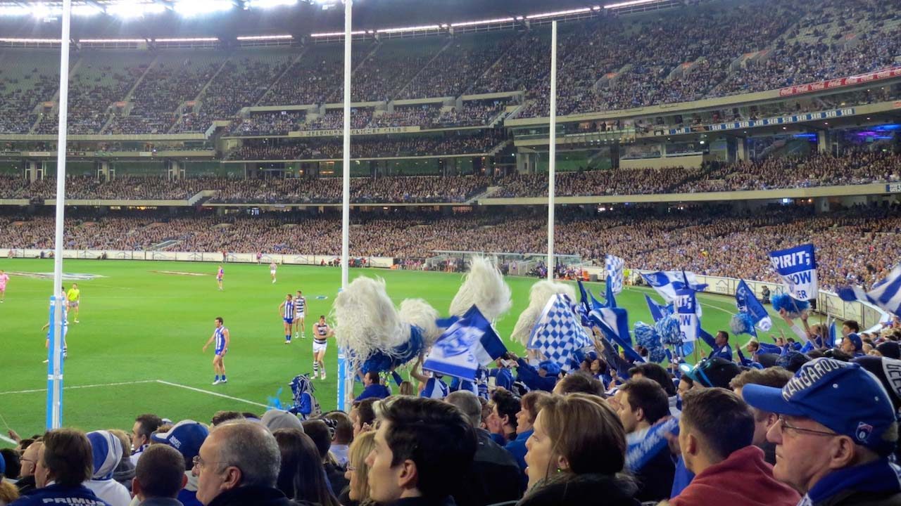 A crowded stadium filled with fans cheering for a football match