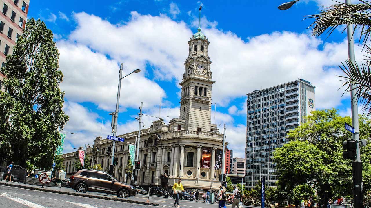 A car speeds down a main street in downtown Auckland