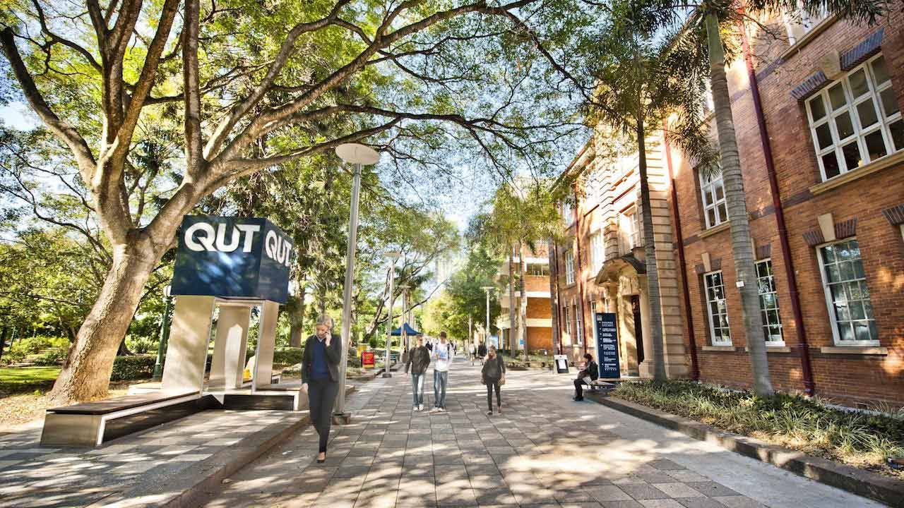 People walk around QUT's Garden Point Campus on a sunny winter day