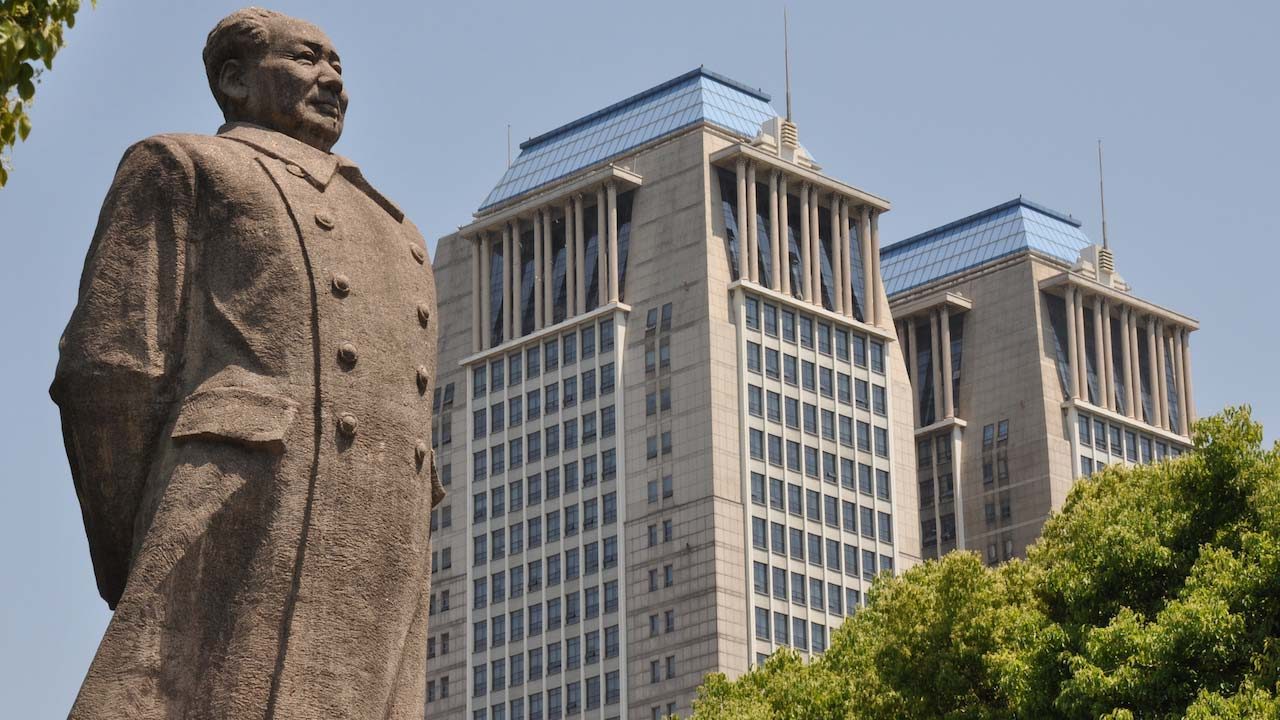 A statue and a building in Shanghai