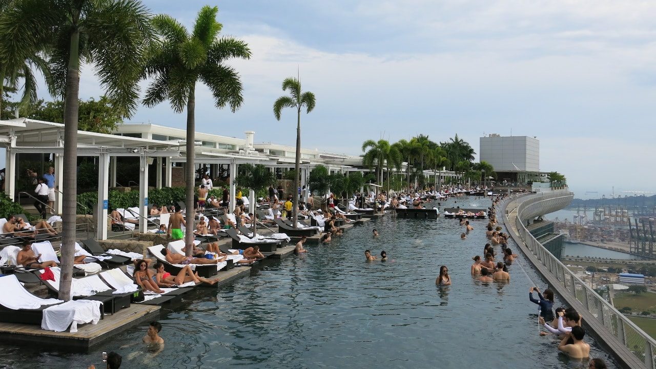 A crowded pool overlooking Singapore