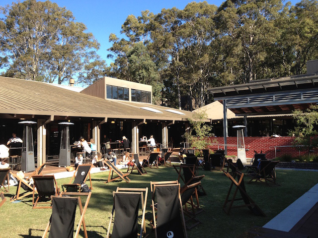 People sitting in lawn chairs enjoying the outdoor area of University of Newcastle's student center